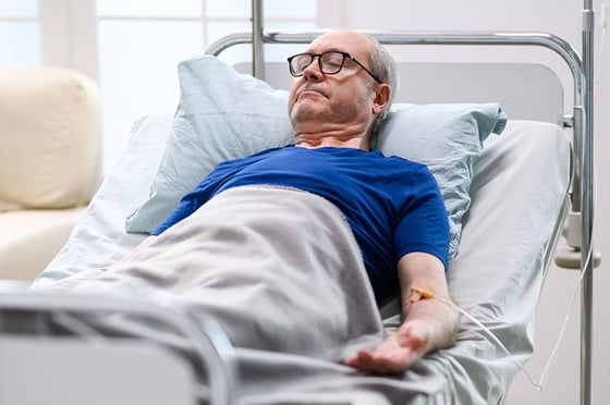 man in hospital bed